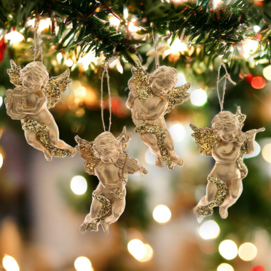 A set of four gold cherub hanging decorations with glitter, designed for Christmas trees or holiday decorations, showing in a blurred background Christmas lights and decorations.