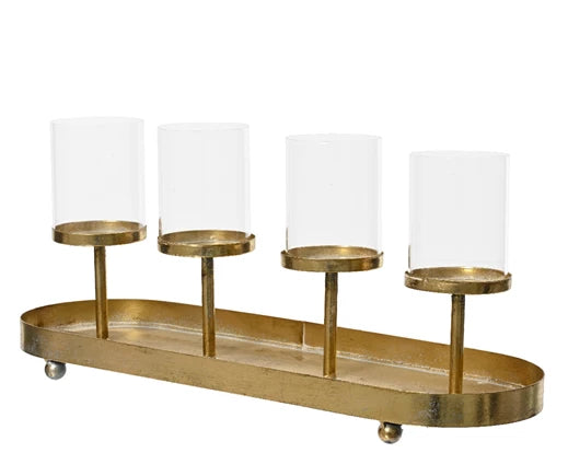 An antique gold vintage style candle holder with four glass hurricane holders and a metal oval tray.