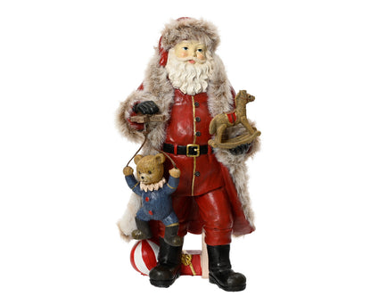 A vintage style ornament of Santa Claus holding traditional Christmas toys, standing 22cm tall.