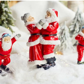 Decorative Santa Claus figures on a snowy background