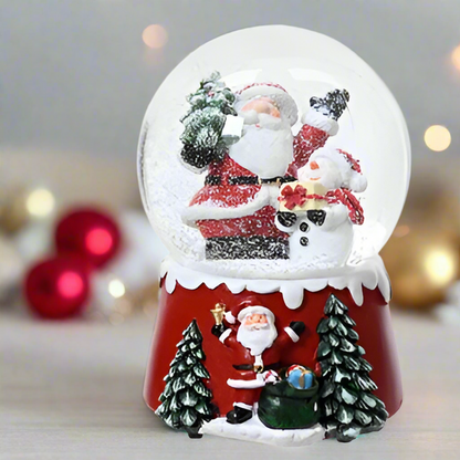 Christmas snow globe with Santa Claus and snowman on a blurred festive background