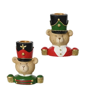 Two decorative teddy bears in festive costumes with top hats on a white background