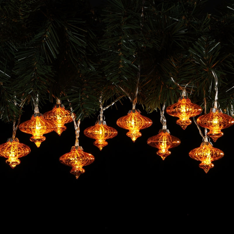 A garland of antique effect glass shades with warm white LED lights, displayed against a dark background.