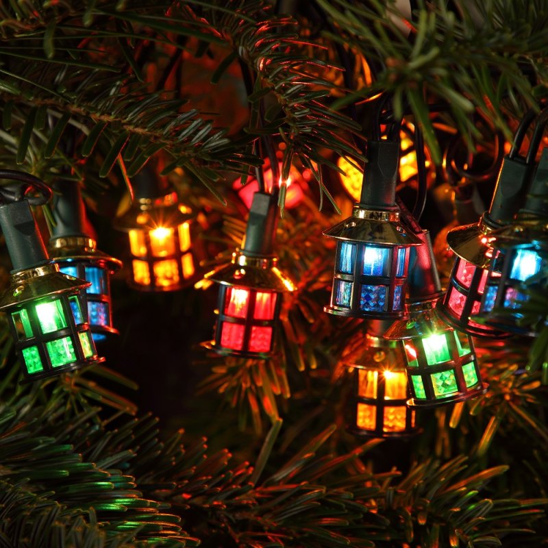 String lights with Victorian style lanterns in multiple colors, displayed on a Christmas tree.