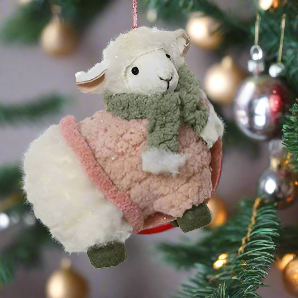 Two fluffy sheep ornaments with knitted sweaters on a white background