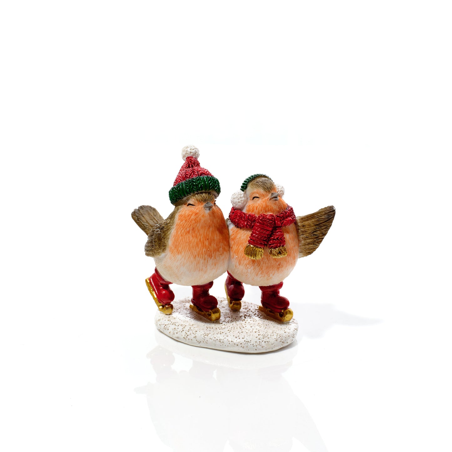 A small decorative figurine of two birds dressed in festive clothing, standing on a glittery white base against a plain white background.