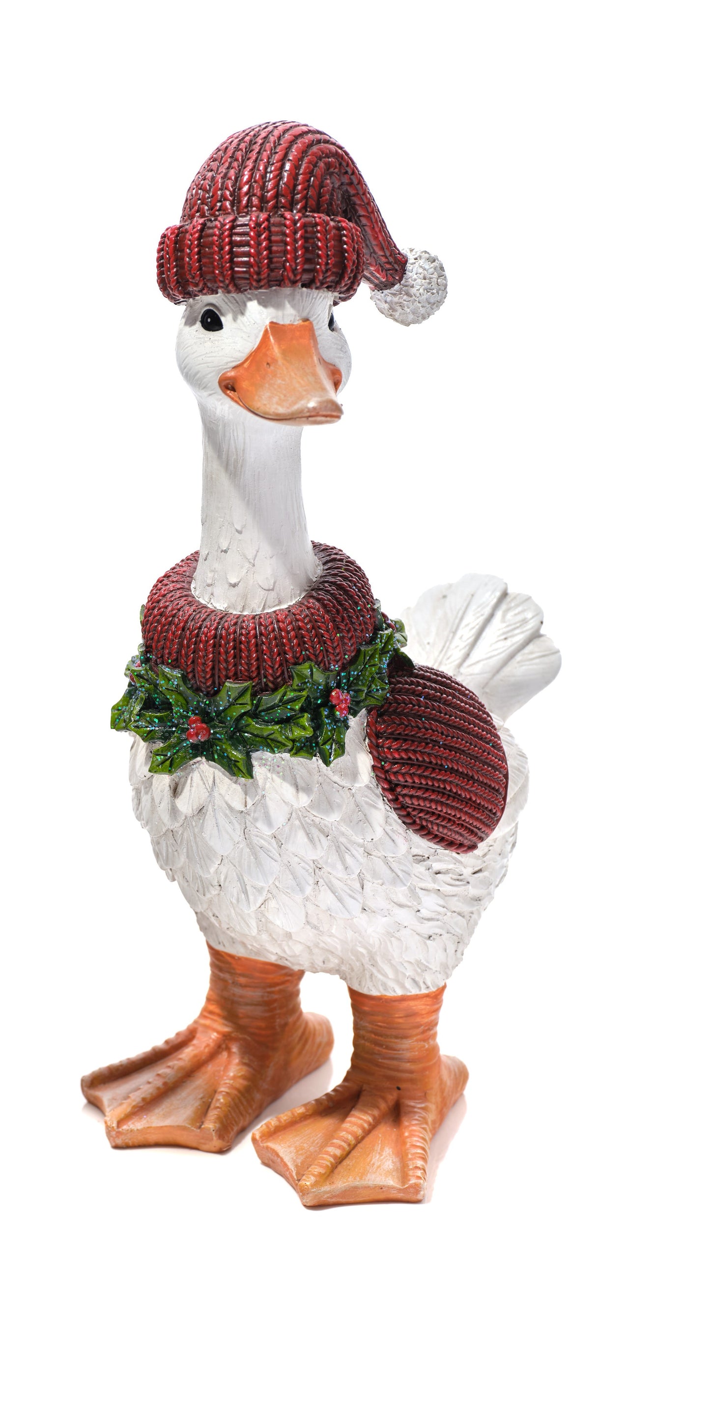 A decorative duck figurine wearing a red knit Santa hat with a white pom-pom, a red knit sweater, and a green holly garland, standing on an orange background.