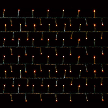 vintage gold string lights in multiple rows of small vertical bulbs on a black background.