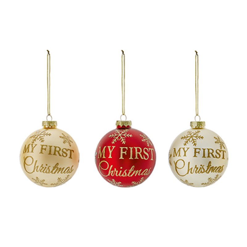 Three Christmas hanging ornaments on a white background: two cream ornaments with gold lettering reading 'MY FIRST Christmas' and one red ornament with gold lettering reading 'MY FIRST Christmas' and gold snowflake details.