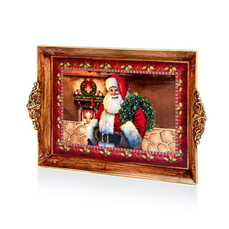 A rectangular decorative tray with ornate gold-toned handles, featuring a printed holiday scene of Santa Claus holding a green wreath, set against a clean white background.