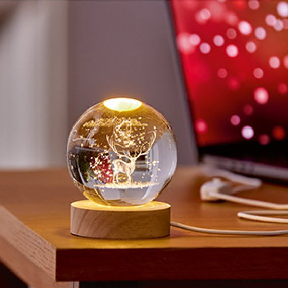 glass ball light on a wooden base with a blurred background