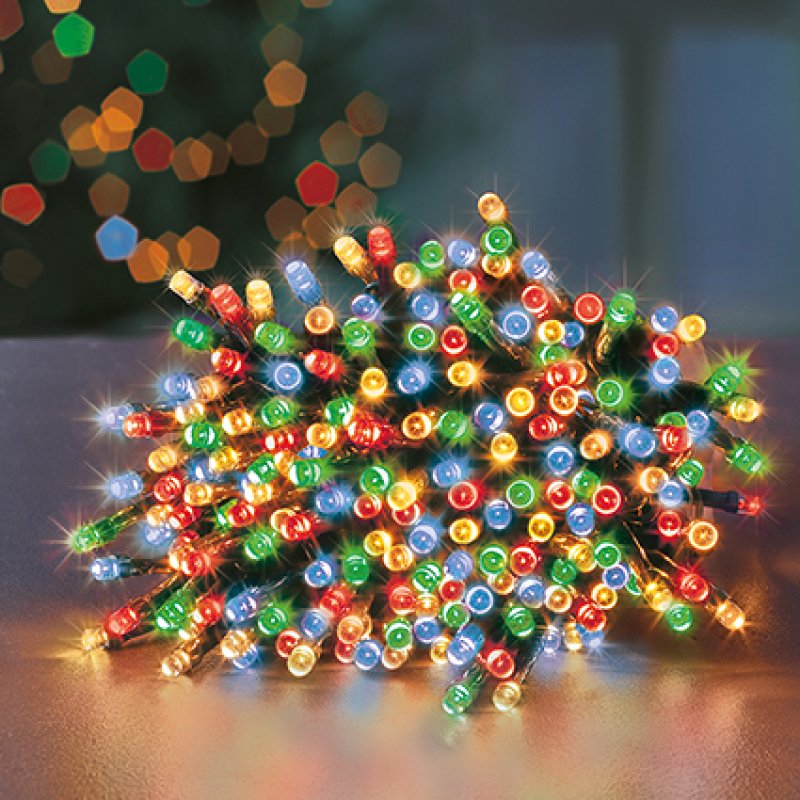 Multicolored string lights on a reflective surface with a blurred background