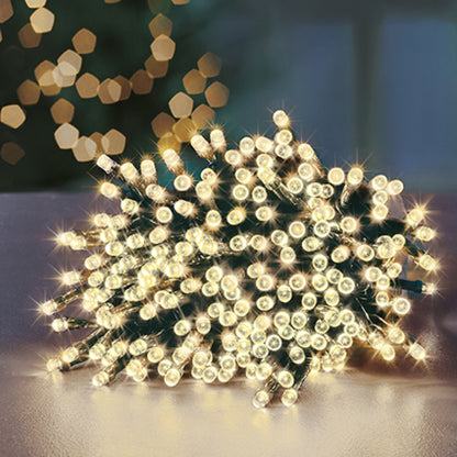 String of lights on a reflective surface with blurred lights in the background