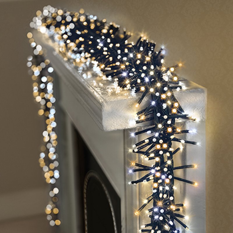 warm white and cool white LED lights draped over a white fireplace mantel.