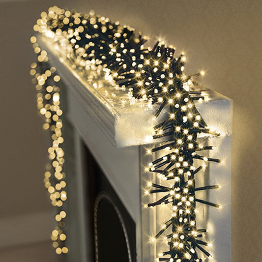 Decorative warm white string lights on a mantelpiece against a neutral wall.