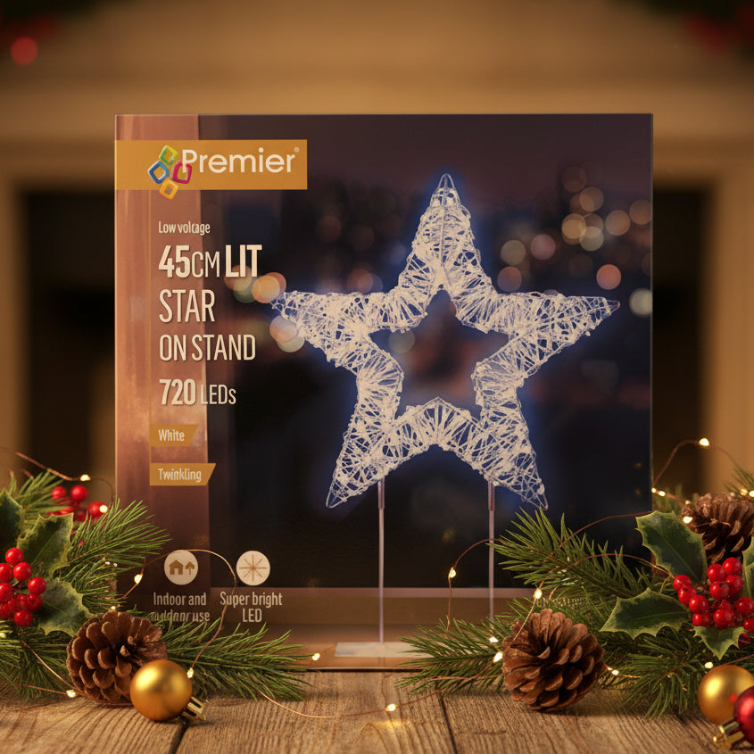 Premier LED star-shaped light on a stand in its retail packaging, featuring a white star wireframe design on a dark background with product details printed on the box.