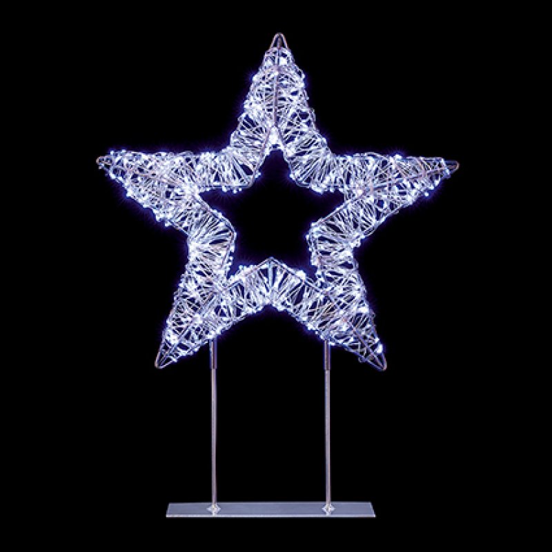 A glowing star-shaped decorative light mounted on two slim metal stands against a solid black background.