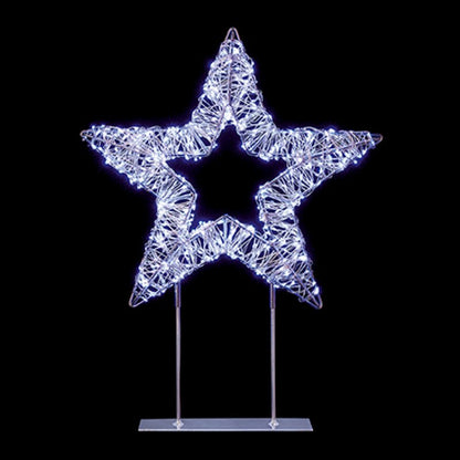 A glowing star-shaped decorative light mounted on two slim metal stands against a solid black background.