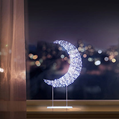 Decorative LED moon light on a stand with a cityscape in the background