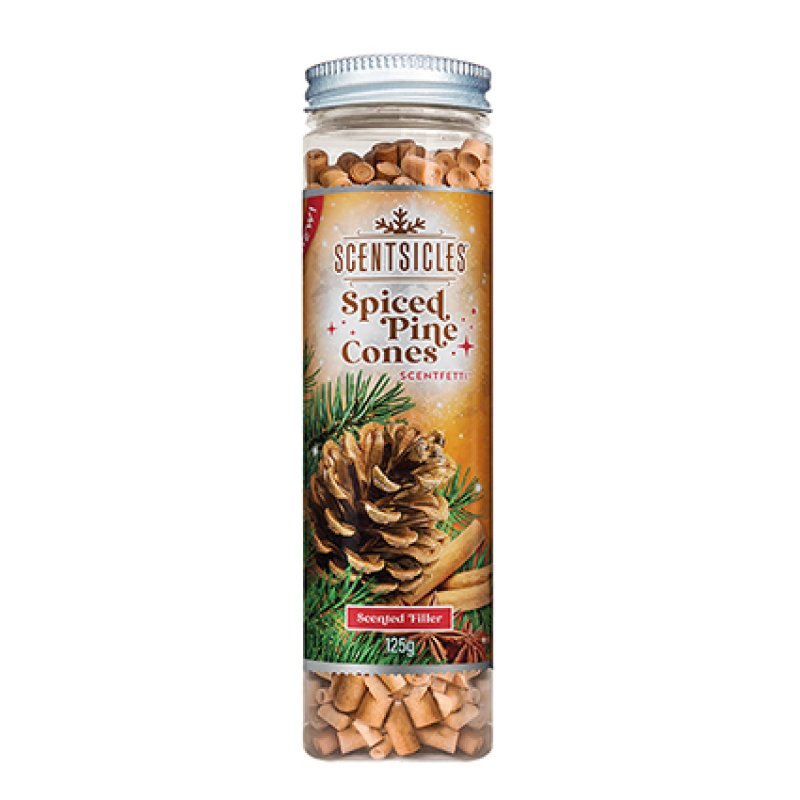 A clear plastic jar of Scentsicles Spiced Pine Cones scented filler, showing the light brown wood chips inside, with a decorative label featuring pine needles, a pinecone, cinnamon sticks, and a silver metal screw cap.
