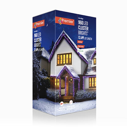 Premier 960 LED cluster lights in a 12.4M light length box, featuring a winter house illustration with purple garlands and warm yellow window lights on a white background.