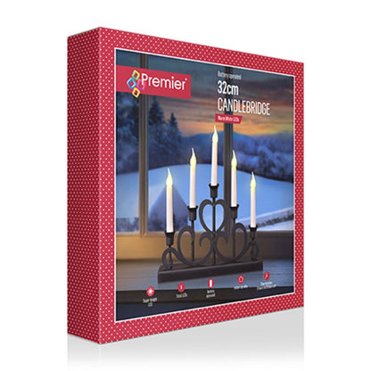 Premier 32cm candlebridge box packaging, featuring a red patterned border and an image of the black metal five-light candle holder with white candles against a snowy window background.