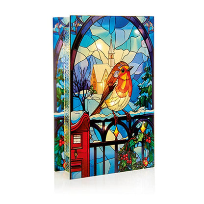 Stylized book with stained glass design featuring a bird and house on a white background