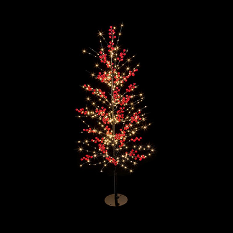 A festive artificial Christmas tree with glowing warm white string lights and clusters of red berries, mounted on a thin black stand with a round base against a solid black background.