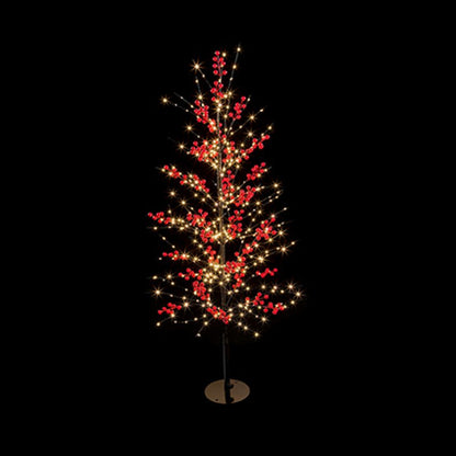 A festive artificial Christmas tree with glowing warm white string lights and clusters of red berries, mounted on a thin black stand with a round base against a solid black background.