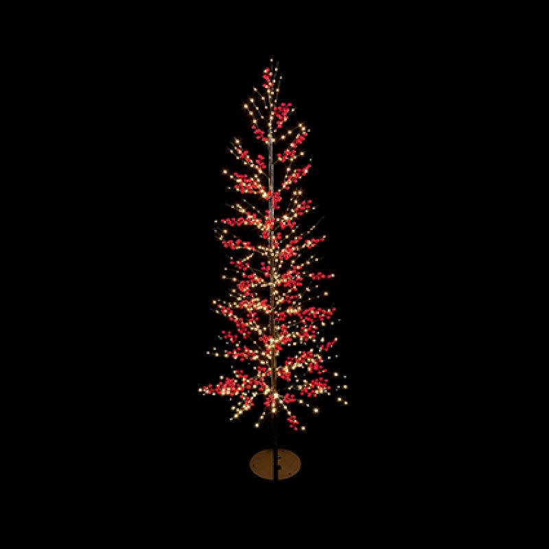 A tall, slender artificial Christmas tree with warm white lights and red berry-like accents, mounted on a small round base against a solid black background.
