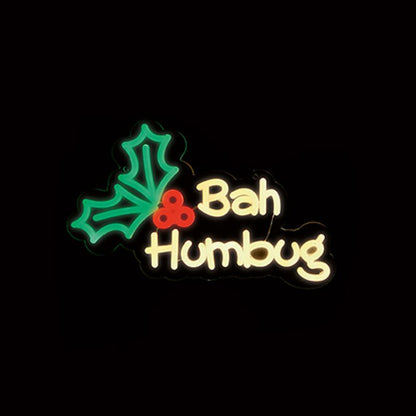 Decorative text 'Bah Humbug' with holly leaves and berries on a black background