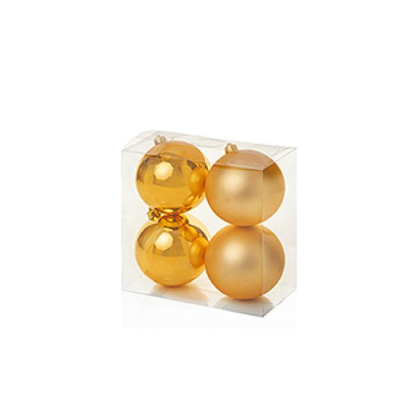 Four gold Christmas ball ornaments in a clear square plastic packaging box, set against a plain white background.