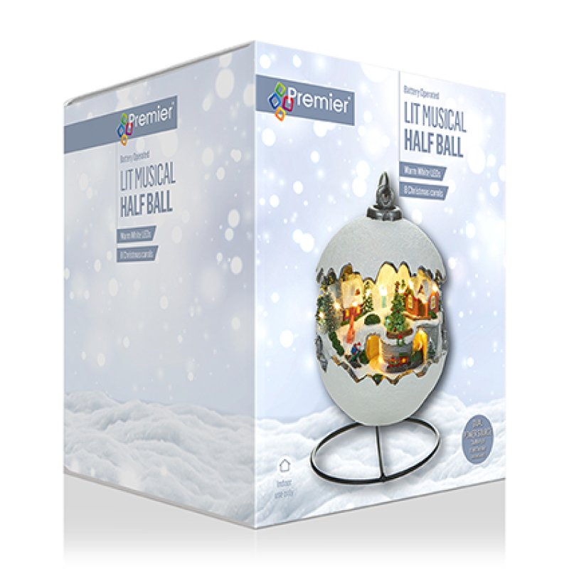 Boxed lighting product labeled Premier Lit Musical Half Ball, shown against a white snowy background with the ornament pictured on the front of the packaging.