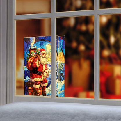 A Christmas-themed stained glass window panel featuring Santa Claus, shown installed on a white-framed window with a warm, festive interior blurred in the background.