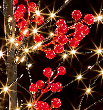 Red berry branch string lights with glowing warm white bulbs on a black background.