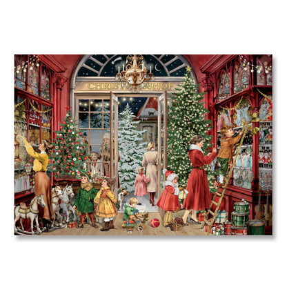 A square art print or poster showing a festive Christmas shop interior with people decorating trees, hanging ornaments, and children playing in a red storefront. The print is photographed against a plain white background.