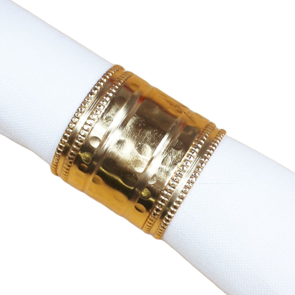 A gold-plated metal napkin holder with decorative beaded edges, shown wrapped around a white napkin on a plain white background.