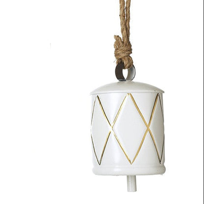 Decorative bell in white with gold geometric patterns on a white background.