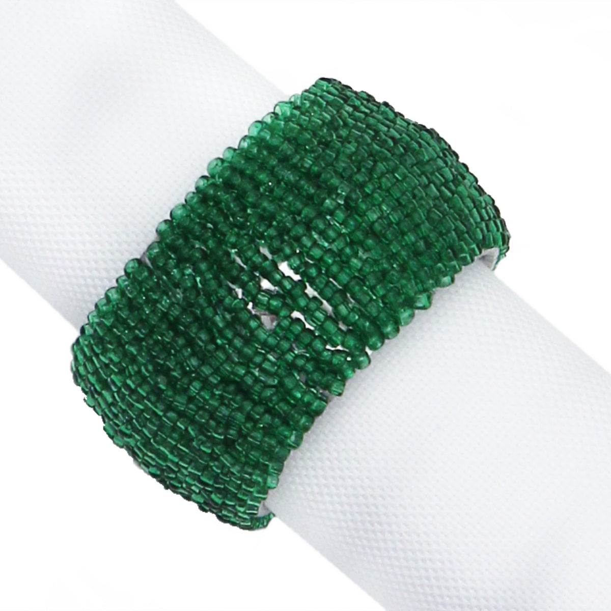 A wide green beaded napkin ring displayed on a white napkin against a white background.