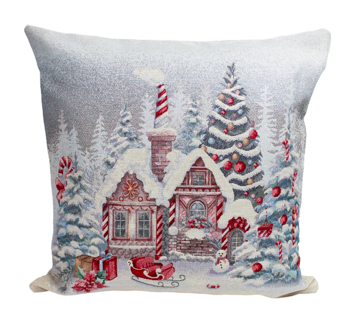 A square decorative throw pillow featuring a festive Christmas village scene with a snow-covered cabin, decorated trees, candy canes, a sleigh, and wrapped gifts on a white background.