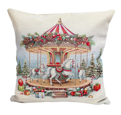 A square decorative throw pillow featuring a festive Christmas carousel design with white horses, red and white striped canopy, pine garlands, evergreen trees, and wrapped gifts on a snowy ground.