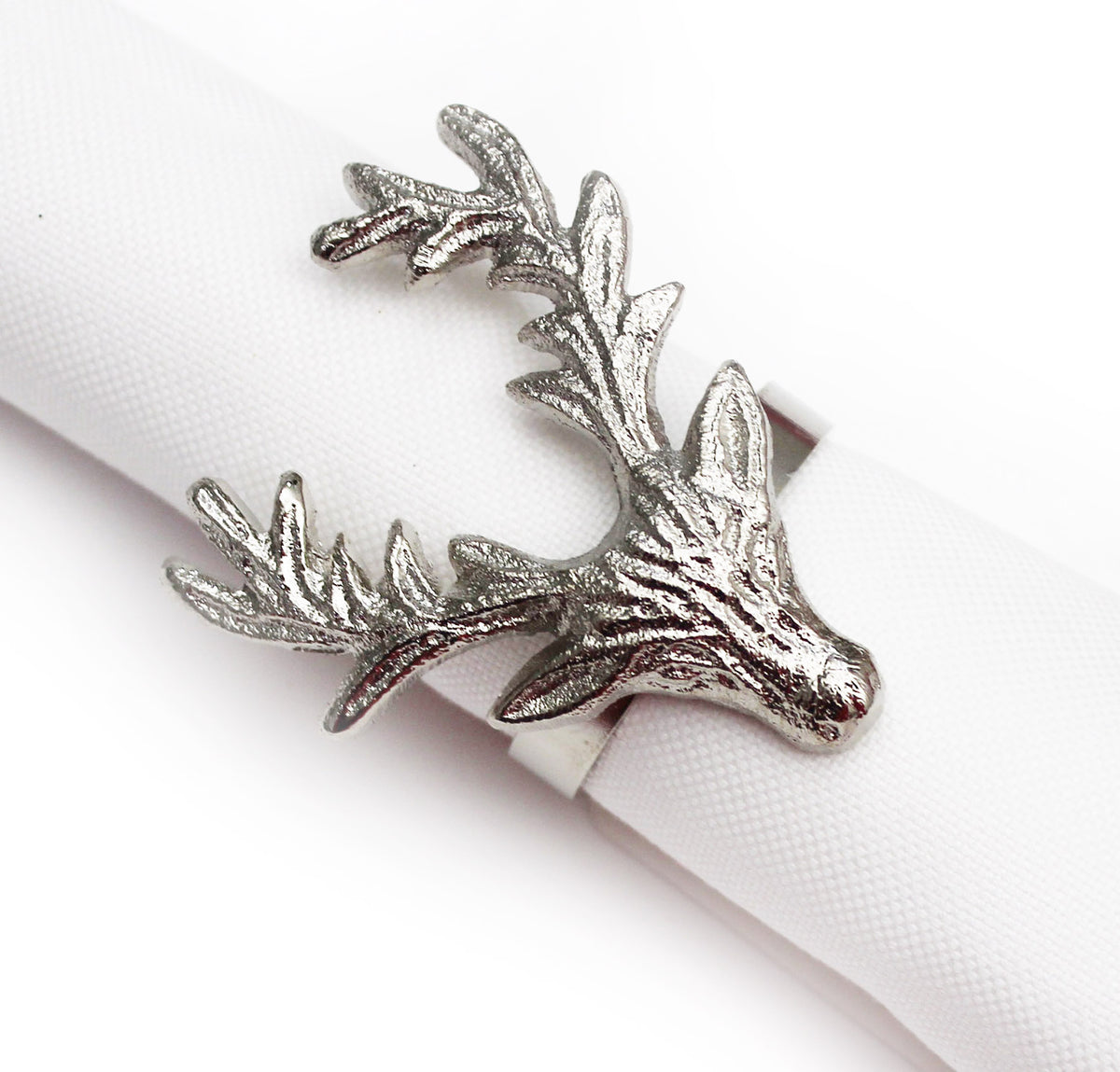 A silver-toned metal deer head napkin ring holding a white textured paper napkin, shown on a clean white background.