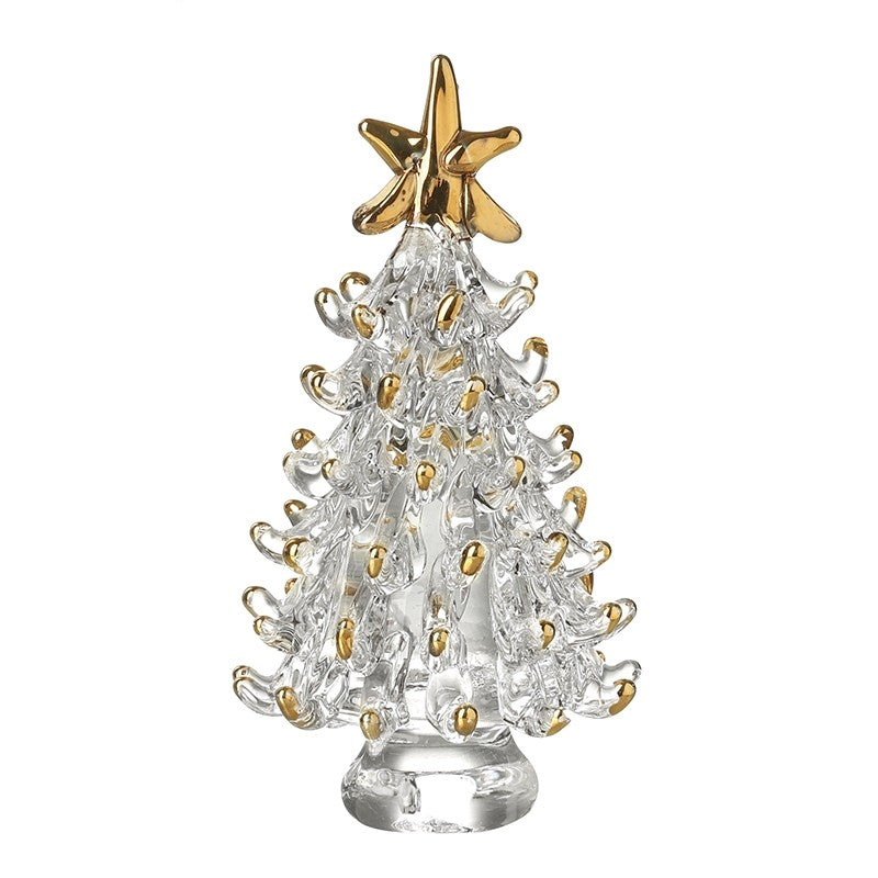 A glass Christmas tree ornament with gold tips and a star on top, standing on a clear base.