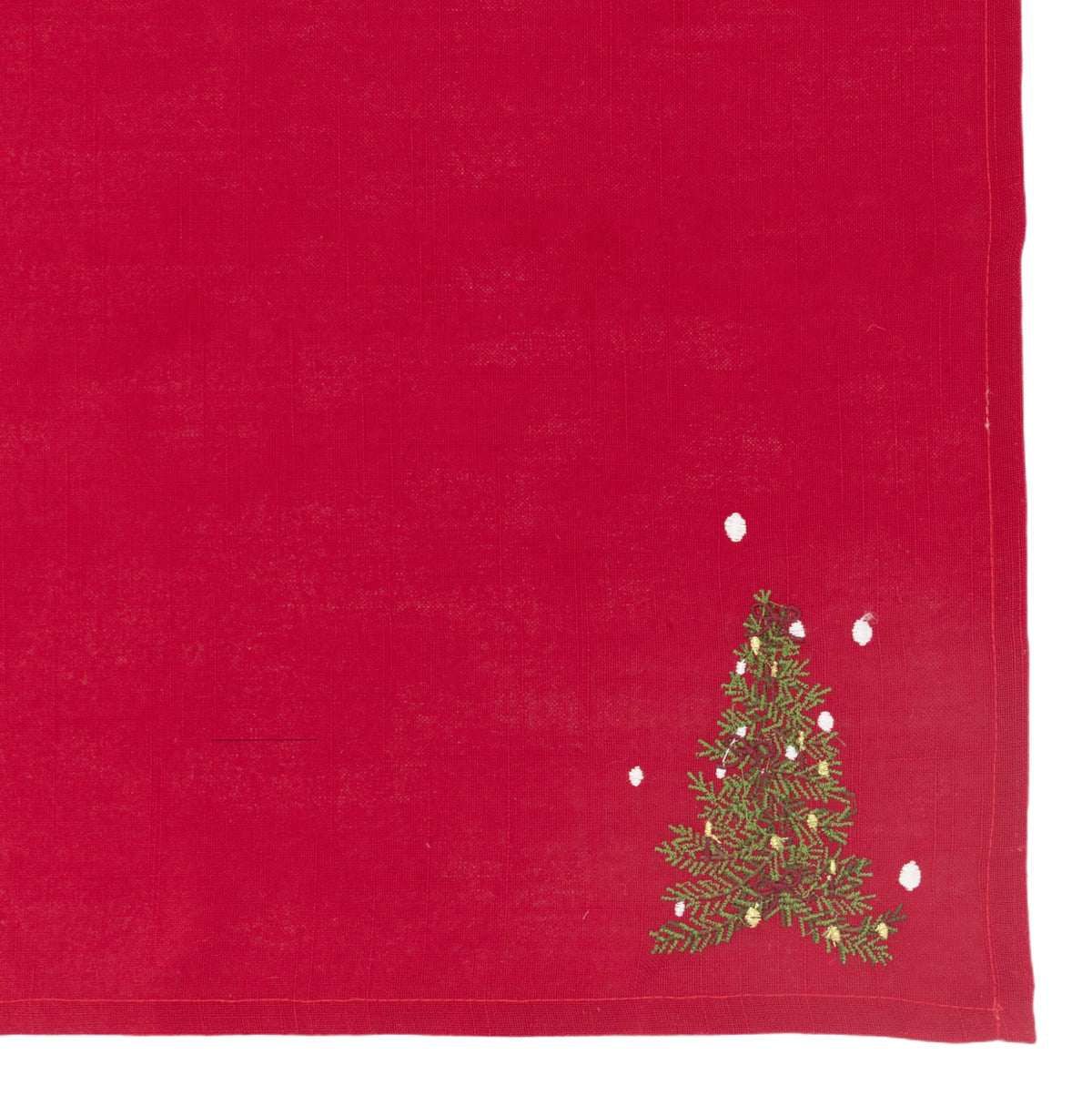 A red napkin with an embroidered Christmas tree and snowflakes in the bottom right corner, shown flat against a white background.
