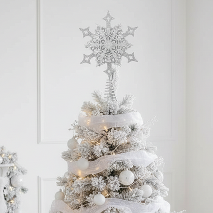 A silver glittery snowflake-shaped ornament designed to be hung on the top of a Christmas tree.