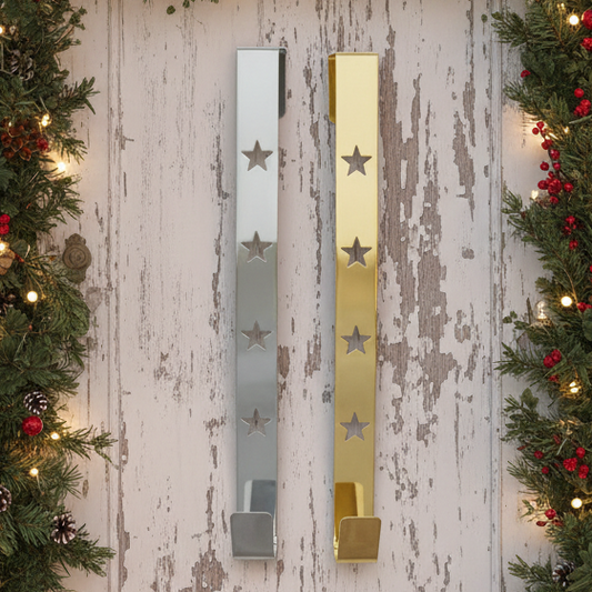 Two star design wreath hangers, one with a silver star cut out on a gold background and the other with a gold star cut out on a silver background.