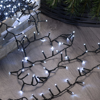 A string of white firefly LED lights placed on a wooden surface, designed for indoor or outdoor decoration.