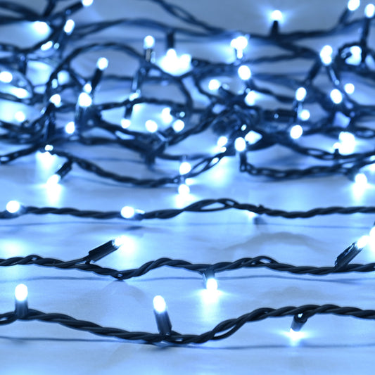 A close-up of heavy duty connectable white Christmas lights with visible bulbs on black cables.