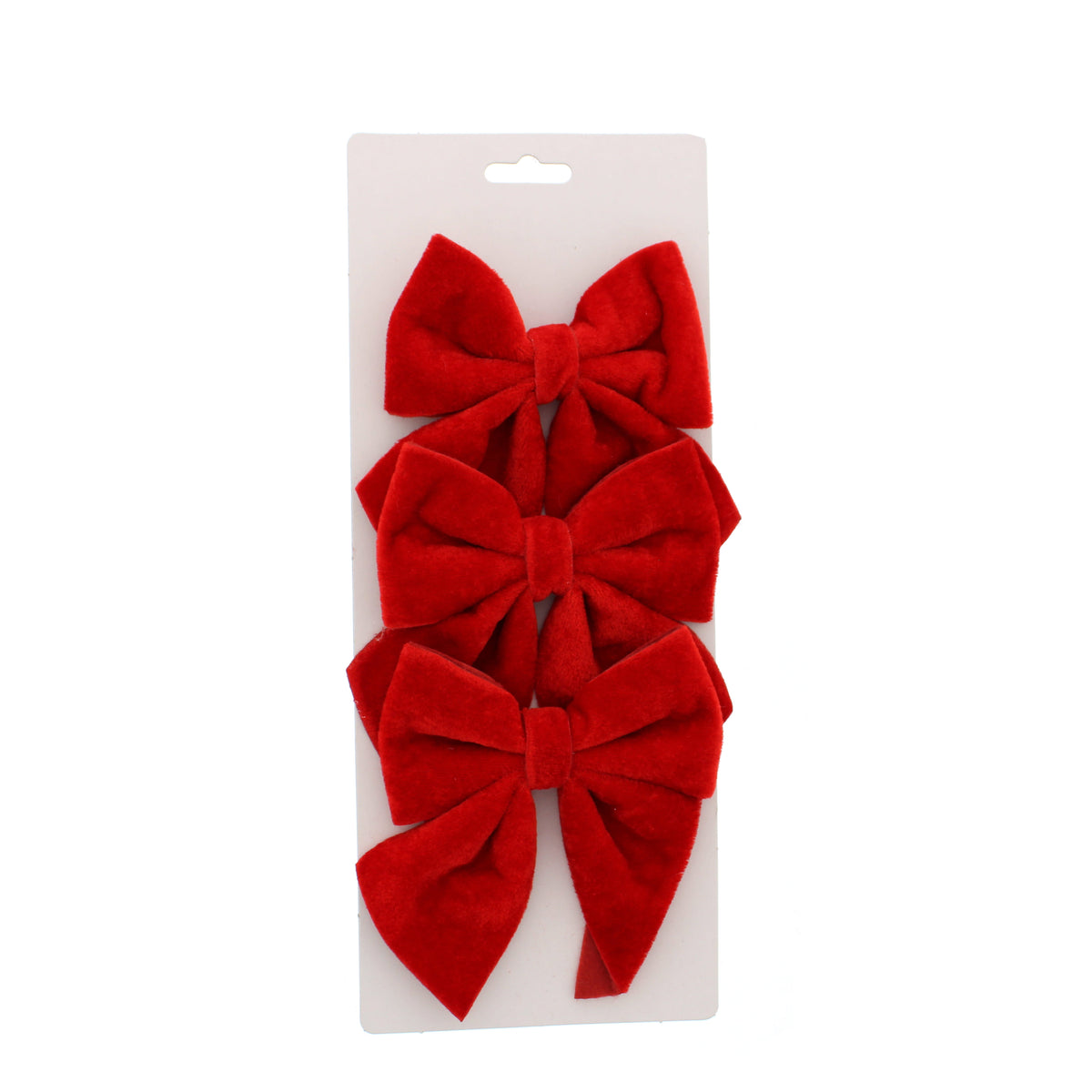 Three red velvet bows stacked vertically on a white cardboard hanger display, photographed against a solid white background.