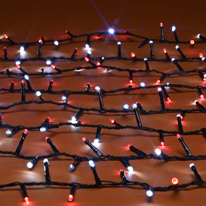 Red, white LED holiday string lights draped across a warm brown surface, glowing with bright starburst effects.